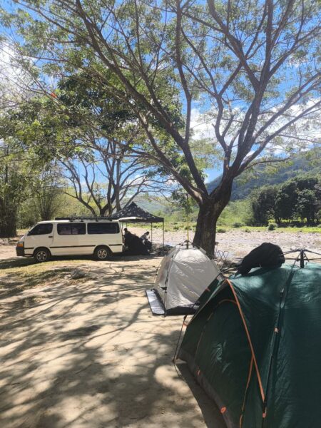 Car camping setup with tents under trees at Marilaque Camp Tanay Rizal
